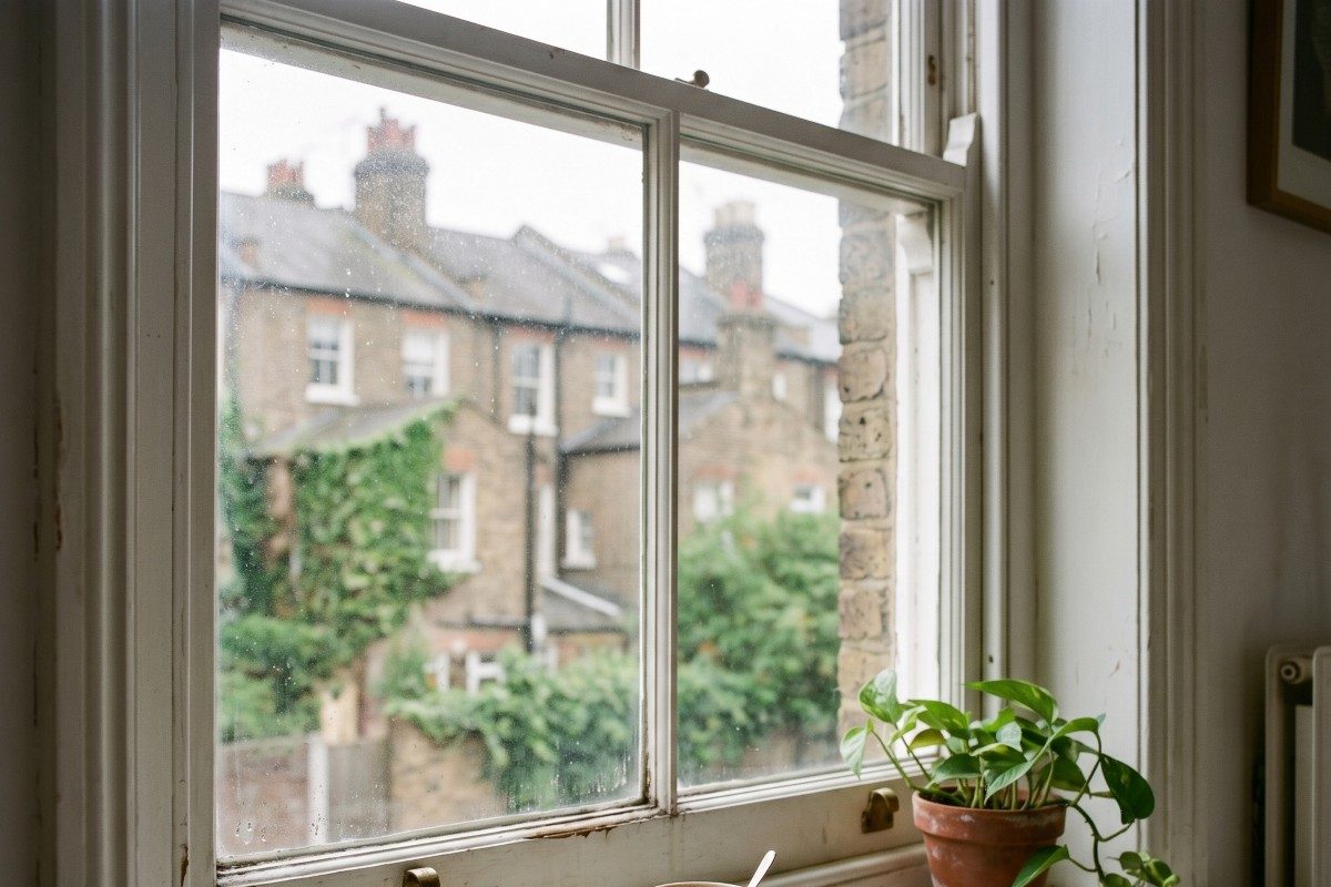inside window sill and lower pane section of a standard Victorian terraced-house sash window in Belsize Park, London